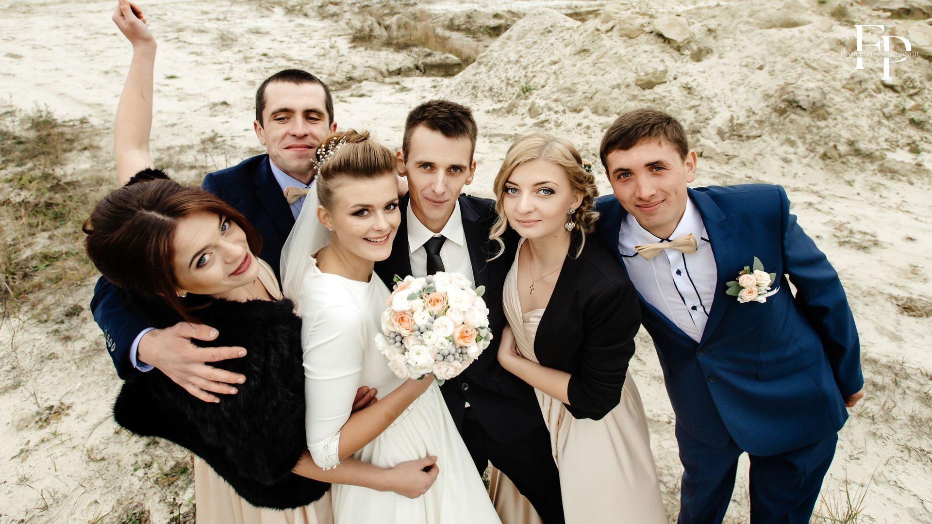 The bride and groom posing for a photo with their friends
