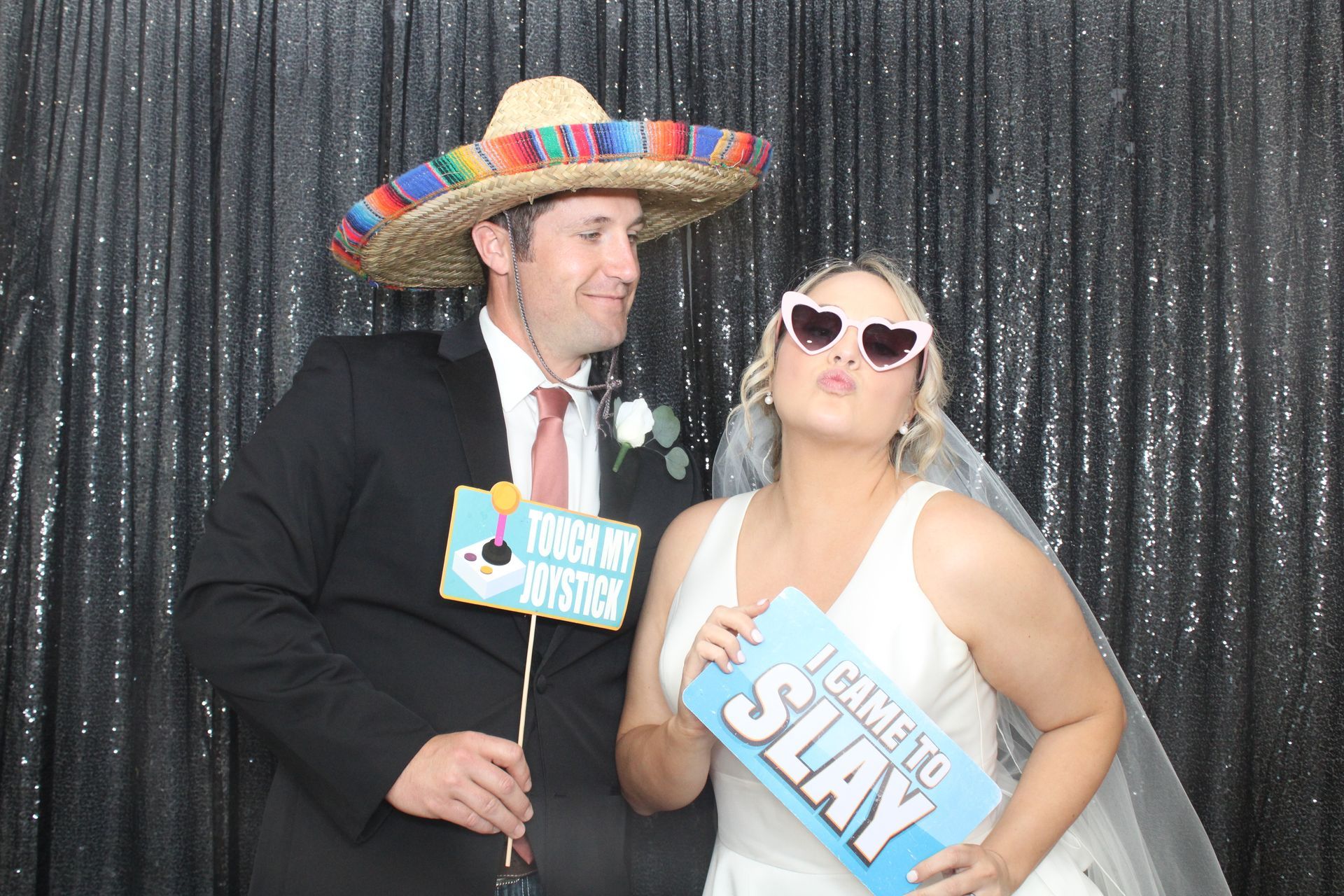 Bride and groom using photo booth at Houston wedding reception
