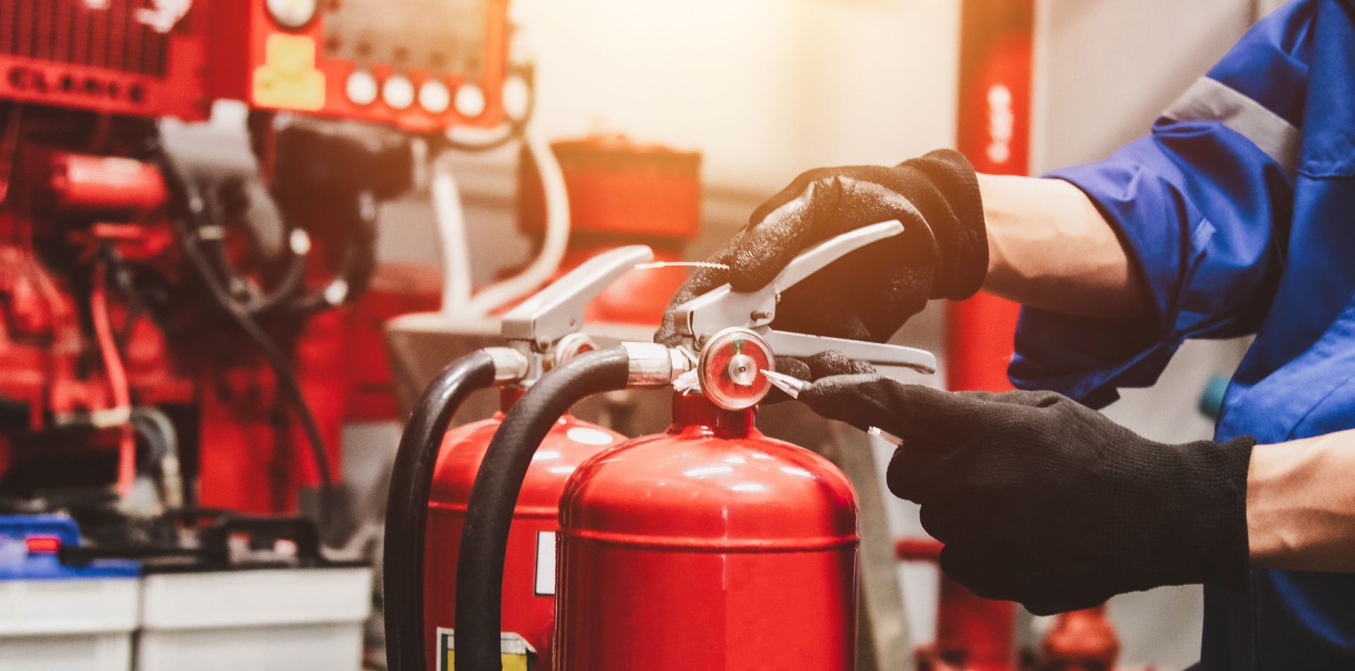 An engineer is checking the fire safety equipment by inspecting the suppression system.