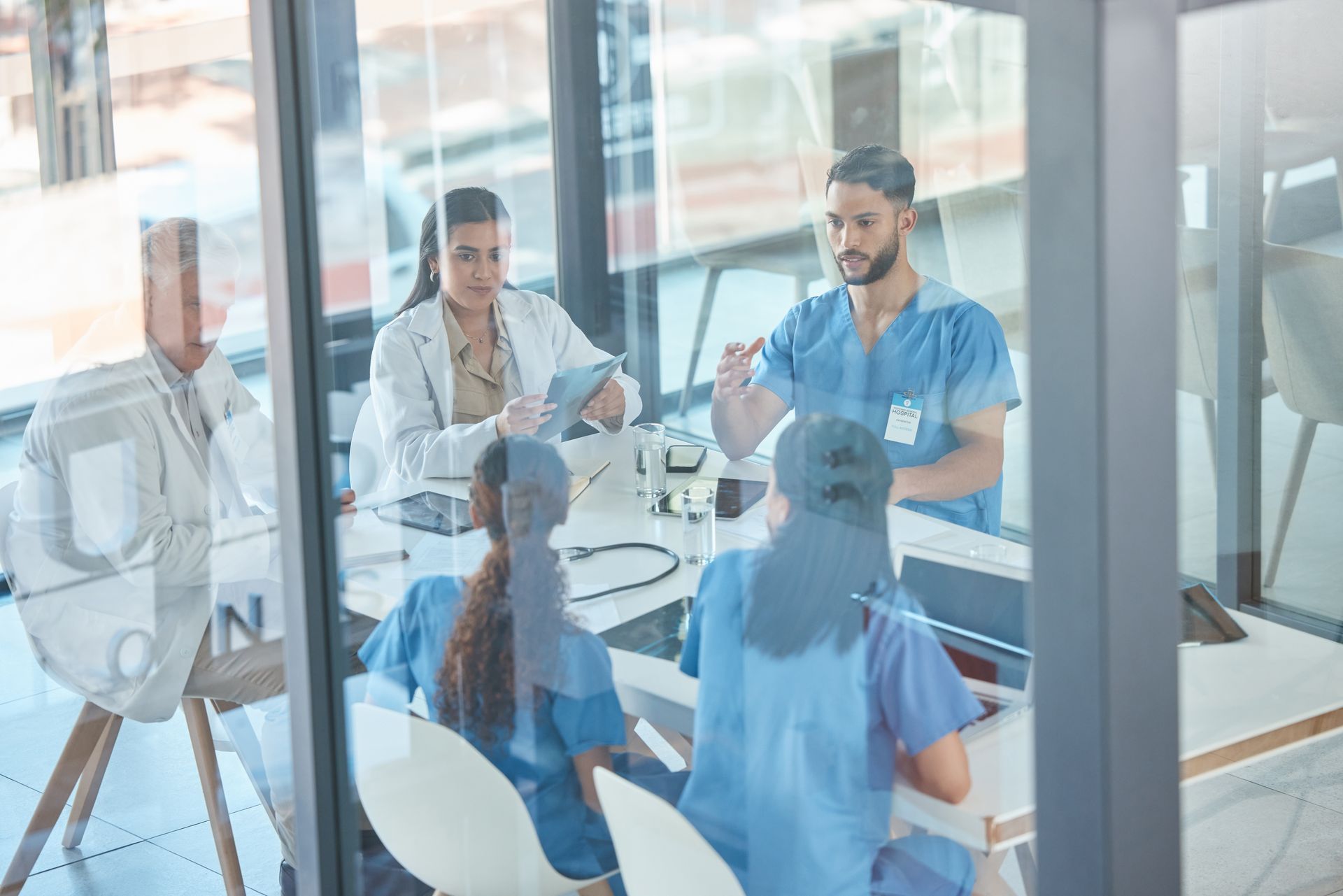 A group of doctors and nurses are having a meeting in a conference room.