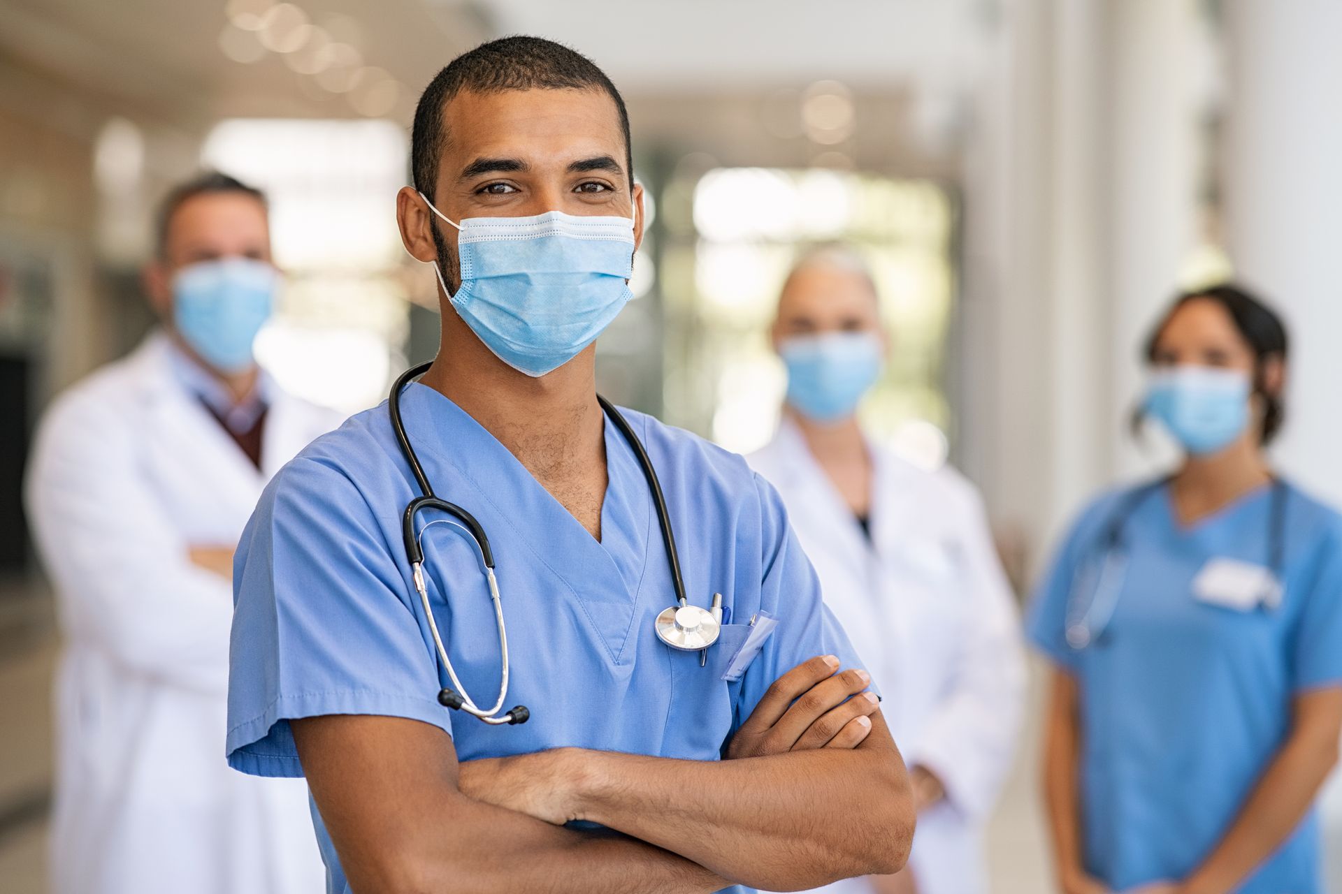 A group of doctors and nurses wearing face masks in a hospital.