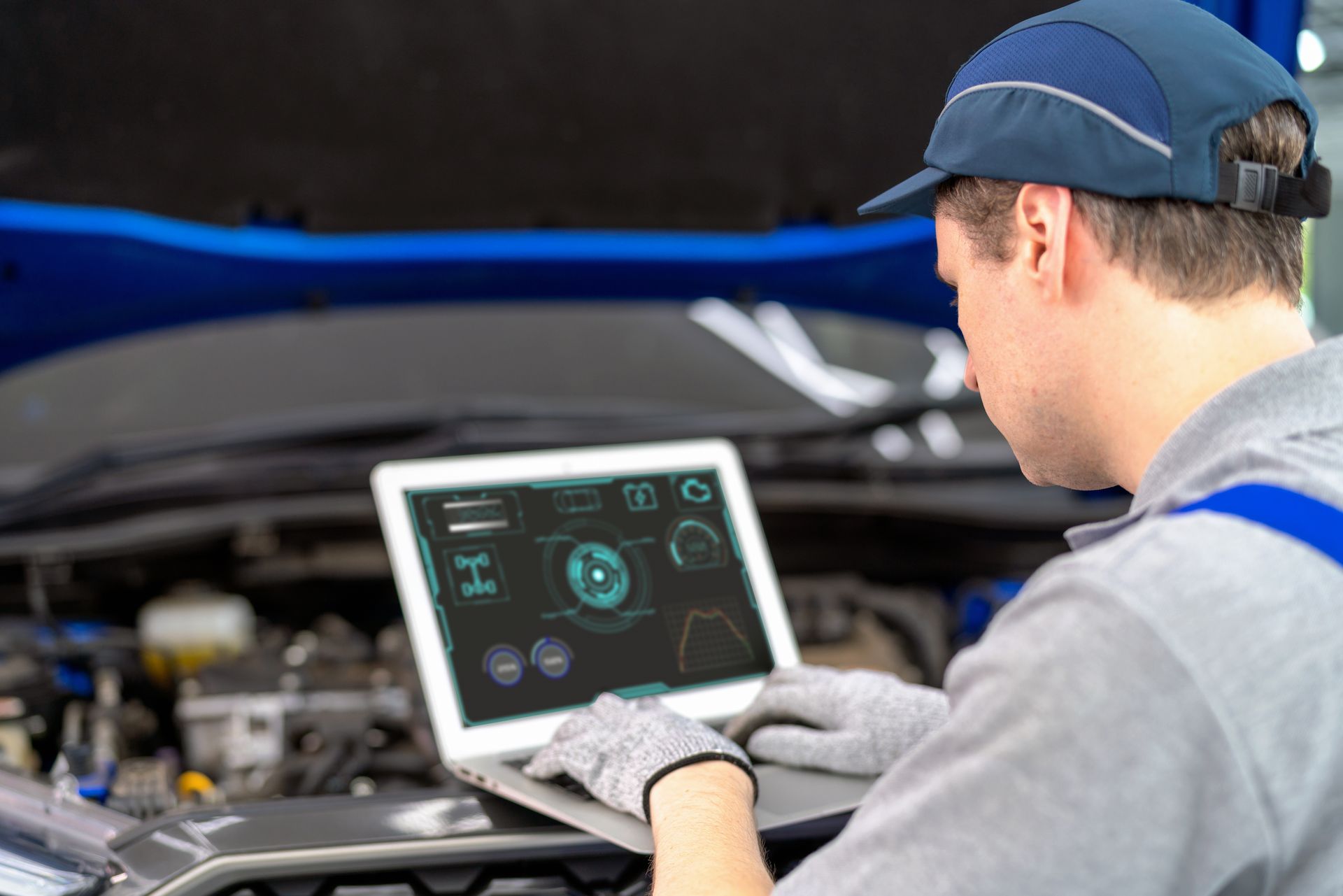 A technician tuning a car engine in a car repair shop