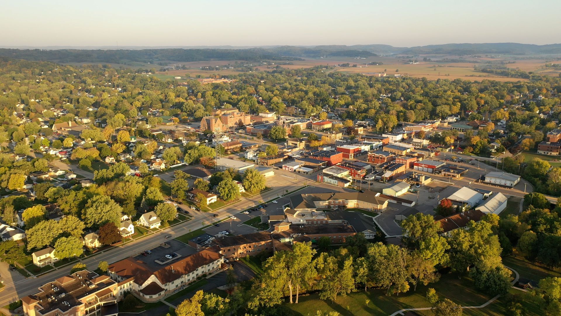 An aerial view of a small town surrounded by trees.