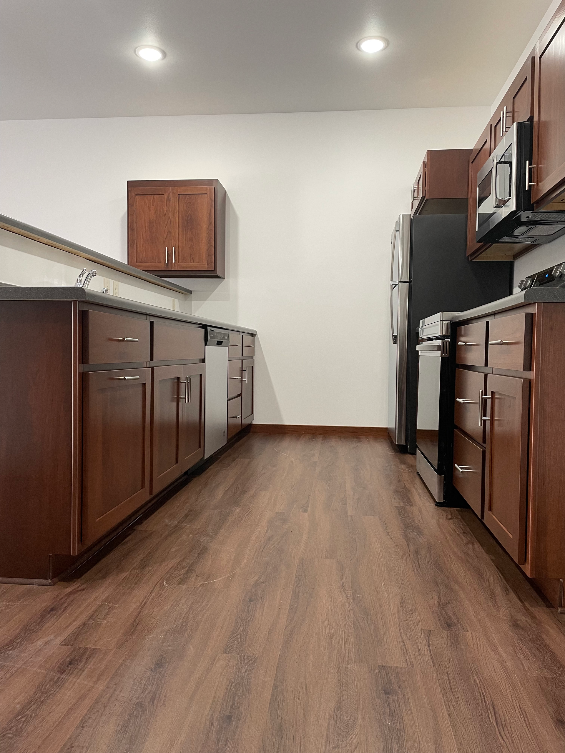 A kitchen with wooden cabinets and stainless steel appliances