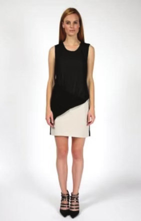 Woman in black and white asymmetrical dress and strappy heels.