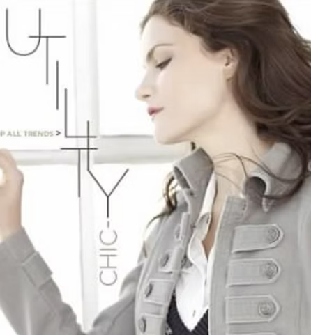 Woman wearing gray jacket, looking away, text reads 