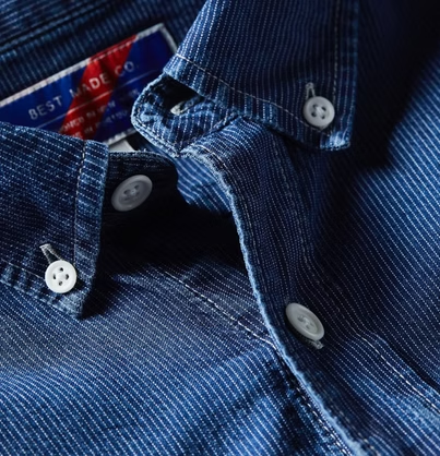 Close-up of a blue denim button-down shirt with a 