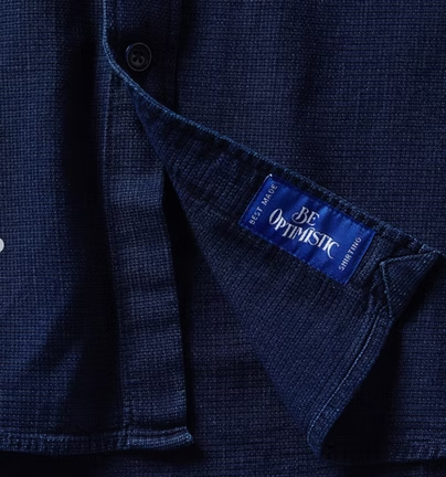 Close-up of a navy blue shirt detail with the label 