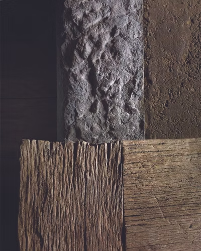 Textured surfaces: rough gray stone, brown dirt, and two wooden panels, one with vertical grain.