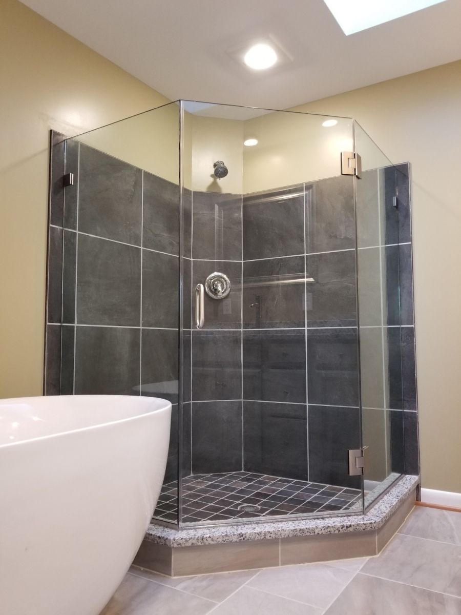 A bathroom with a walk in shower and a bathtub