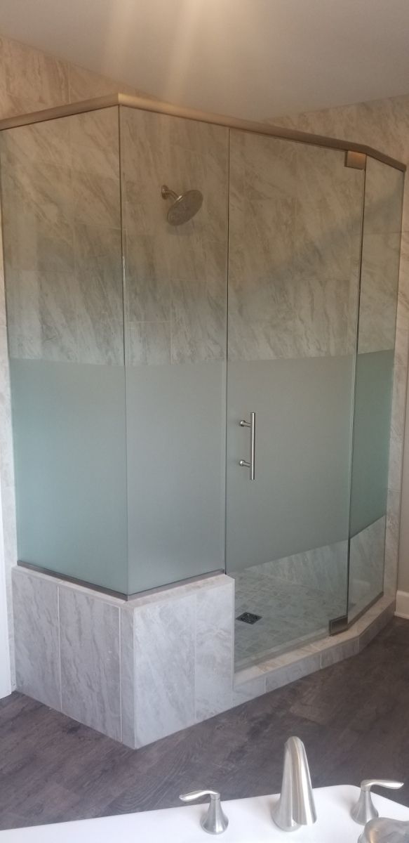 A bathroom with a walk in shower and a bathtub.