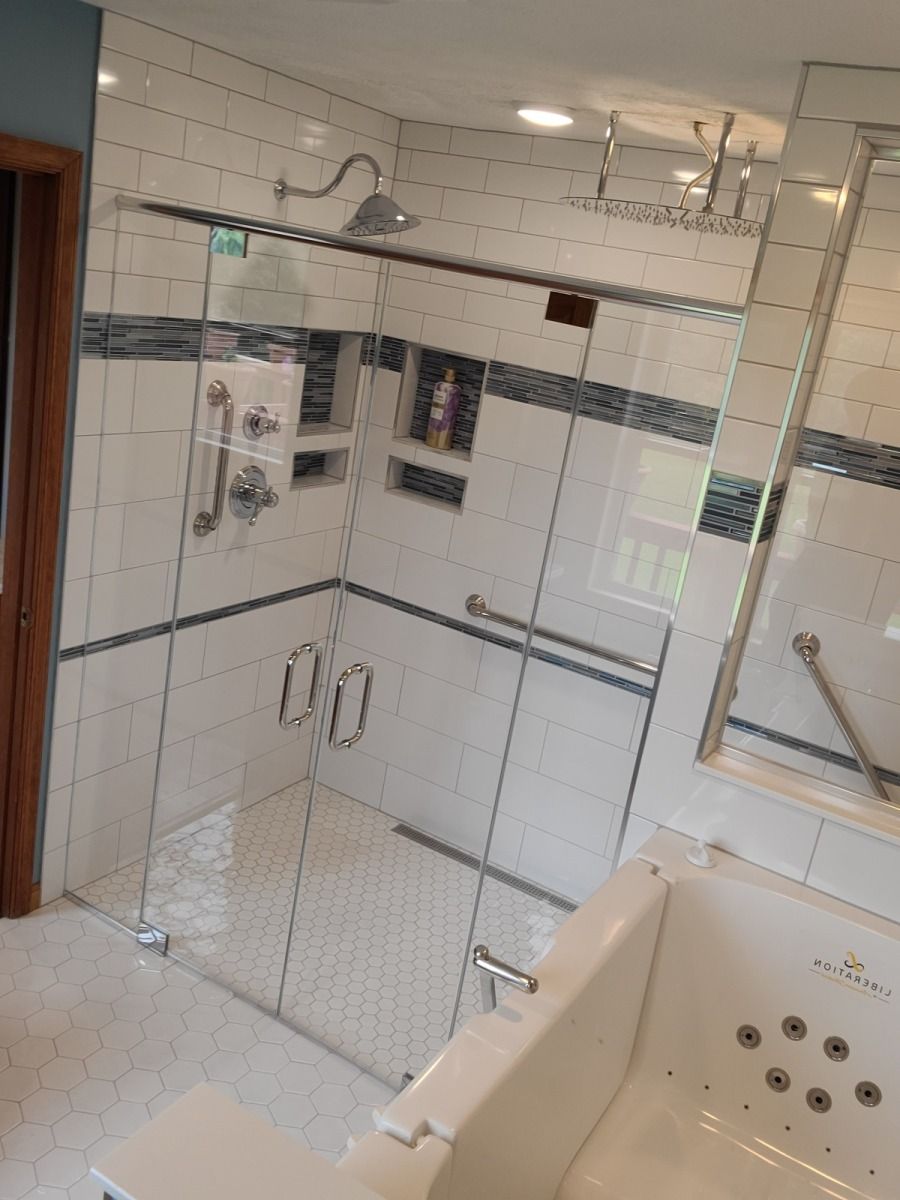 A bathroom with a walk in shower and a bathtub.