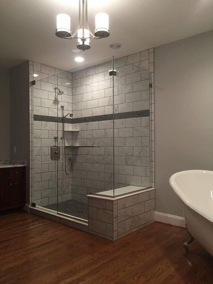 A bathroom with a walk in shower and a bathtub.