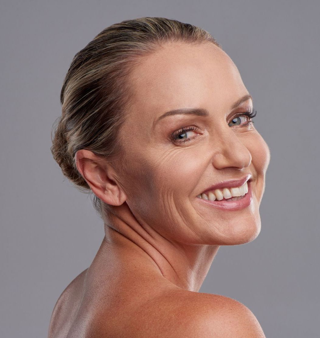 Woman Smiling Over Shoulder— Savannah, GA — The Smile & Face Company