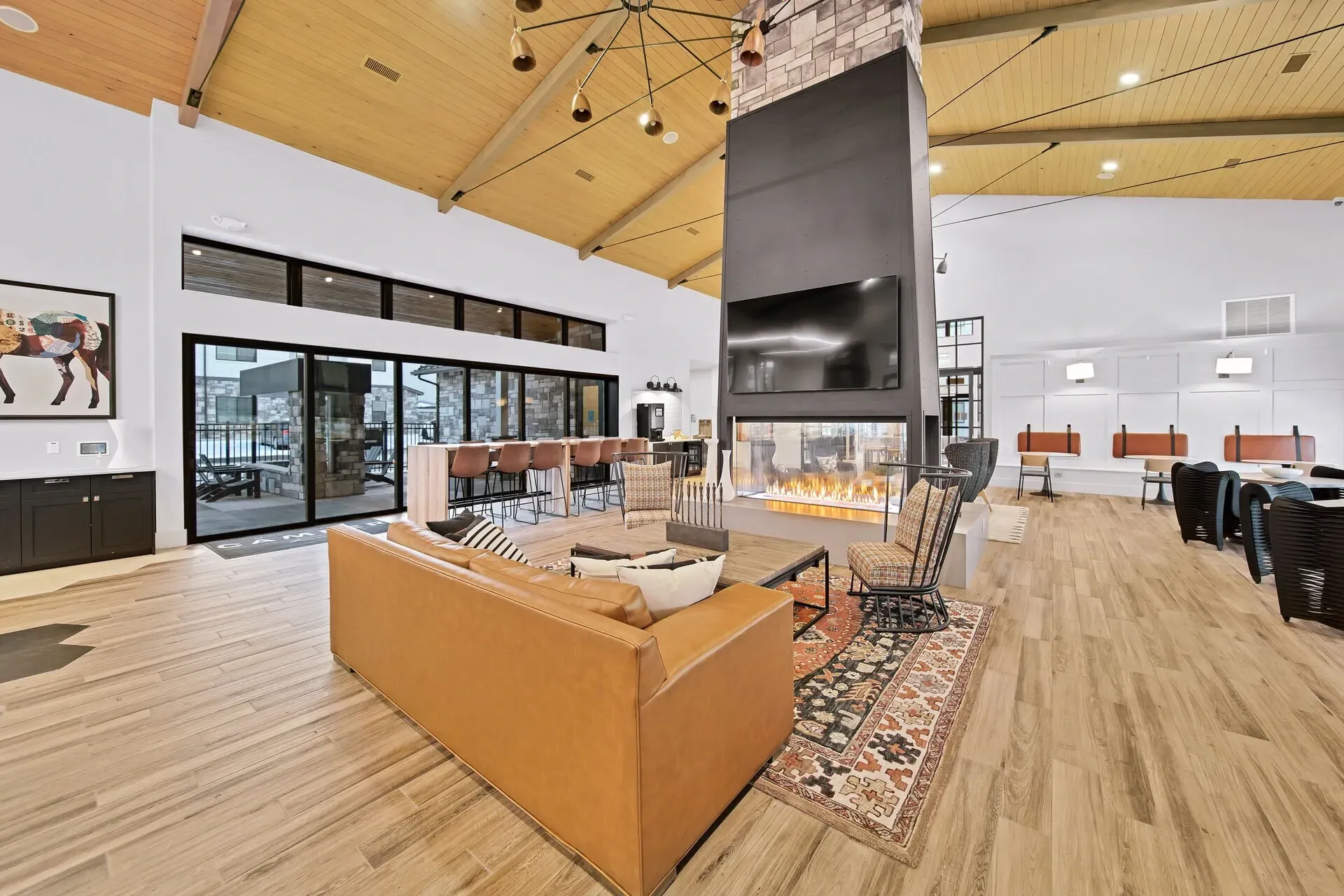 Modern lounge area with a large fireplace and seating.