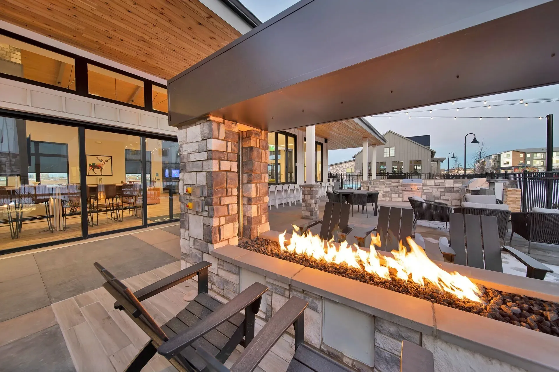Outdoor fire pit area with seating and grills.