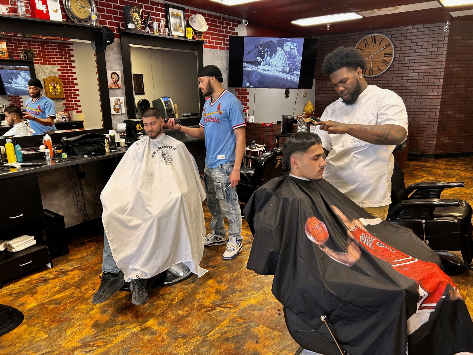 a man is getting his hair cut at a barber shop .