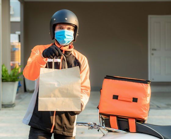 Deliveryman with mask handing bag - Free Home Delivery in Camden North Haven, NSW