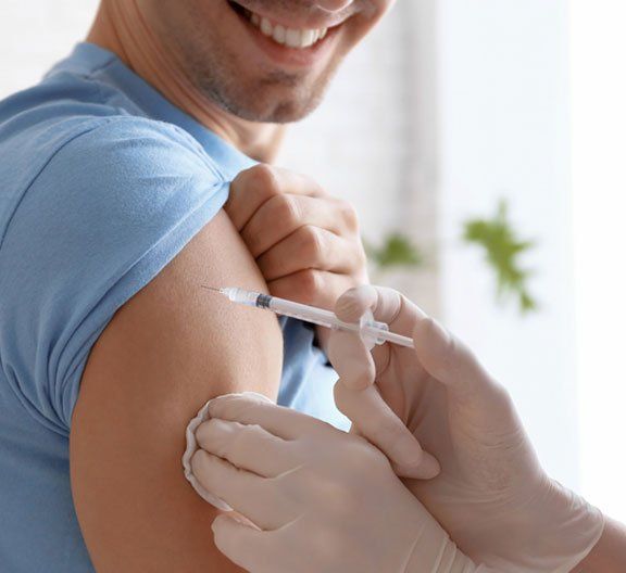 Man happily taking vaccination -  Vaccination in Camden North Haven, NSW