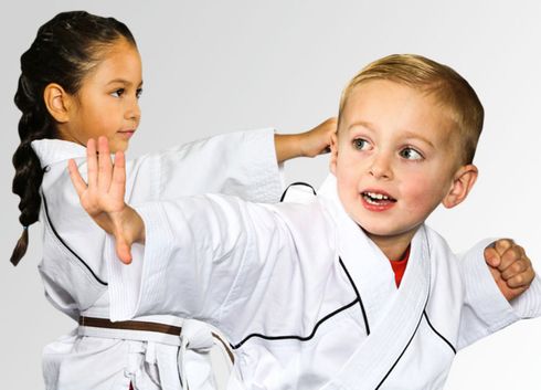 martial arts student ages 4 practicing in class