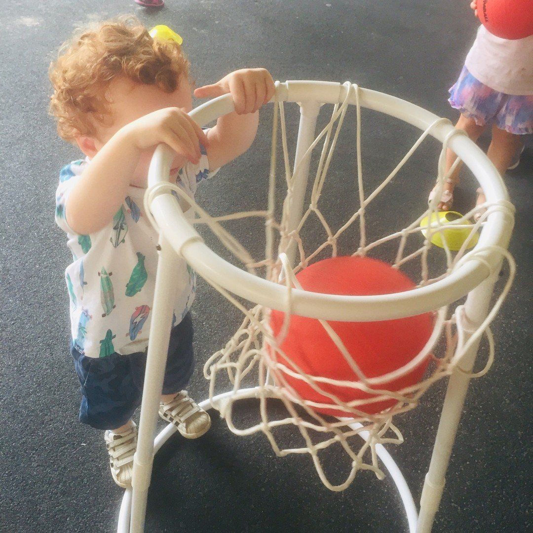 little child playing net ball