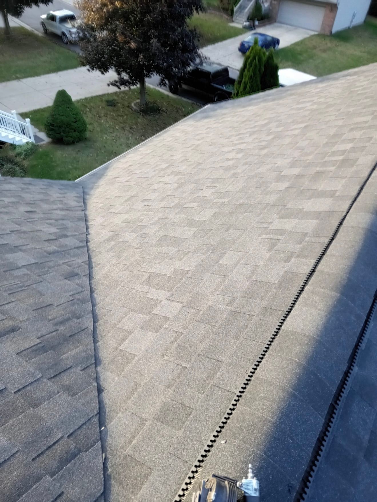 A roof with a lot of shingles and a drain on it