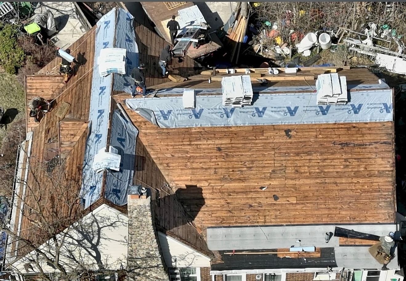 An aerial view of a house under construction with a wooden roof.