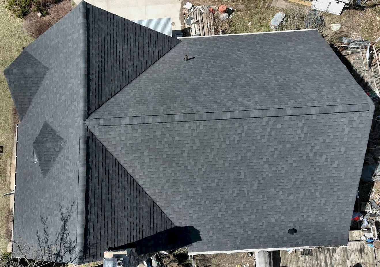 An aerial view of a house with a black roof.