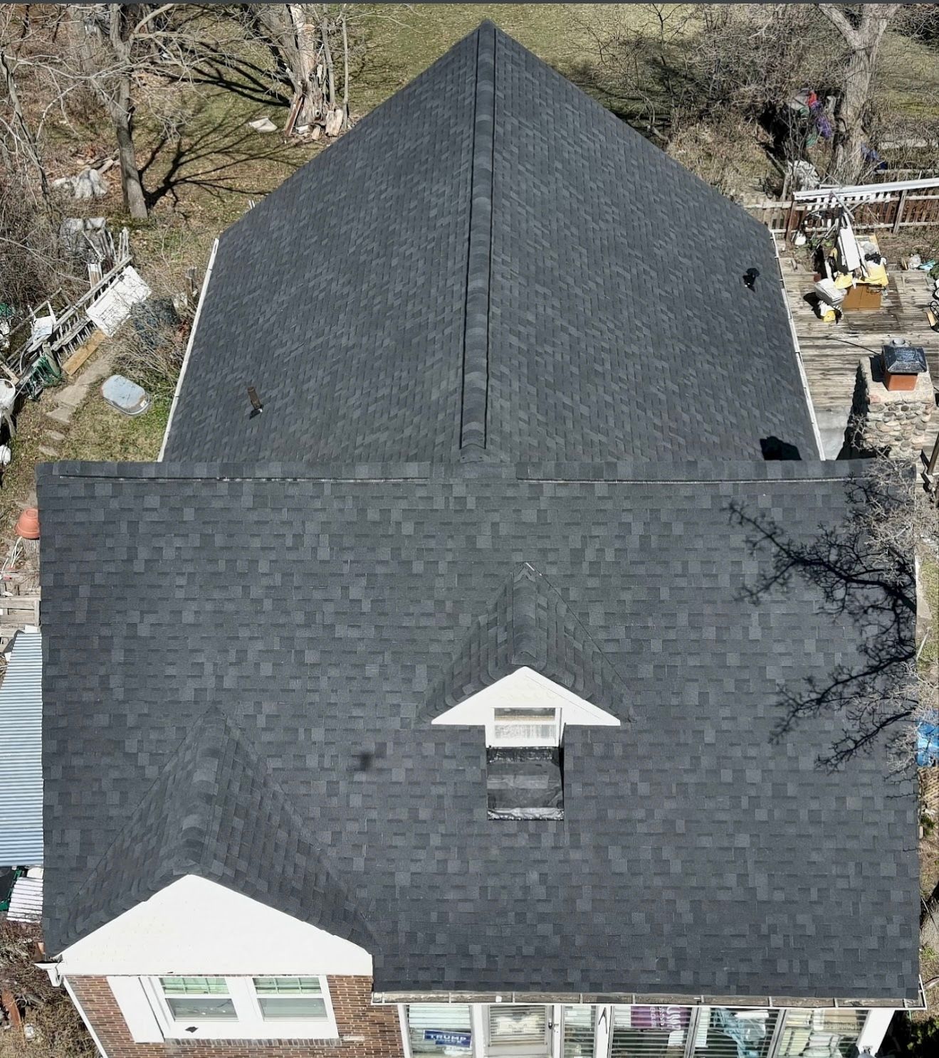 An aerial view of a house with a black roof.