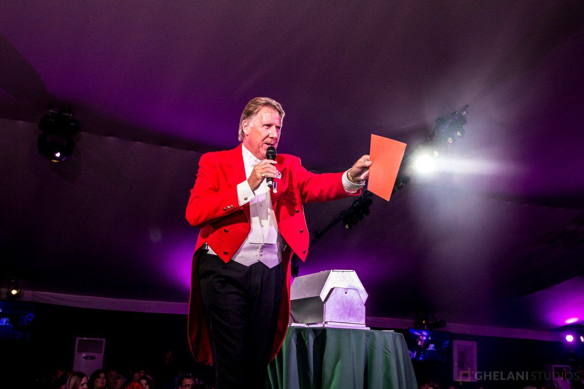 toastmaster on stage at event in london, photo by ghelani studios event photos