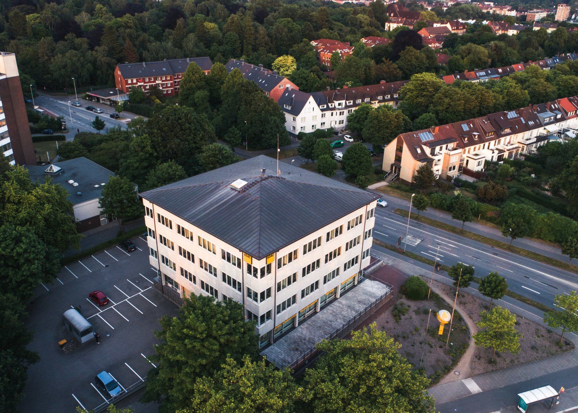 Eine Luftaufnahme eines Gebäudes mit einem Parkplatz davor