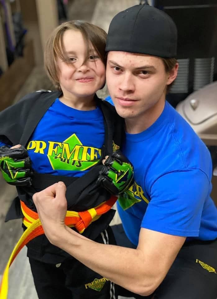 A person is holding a sparkler in their hand in the dark.