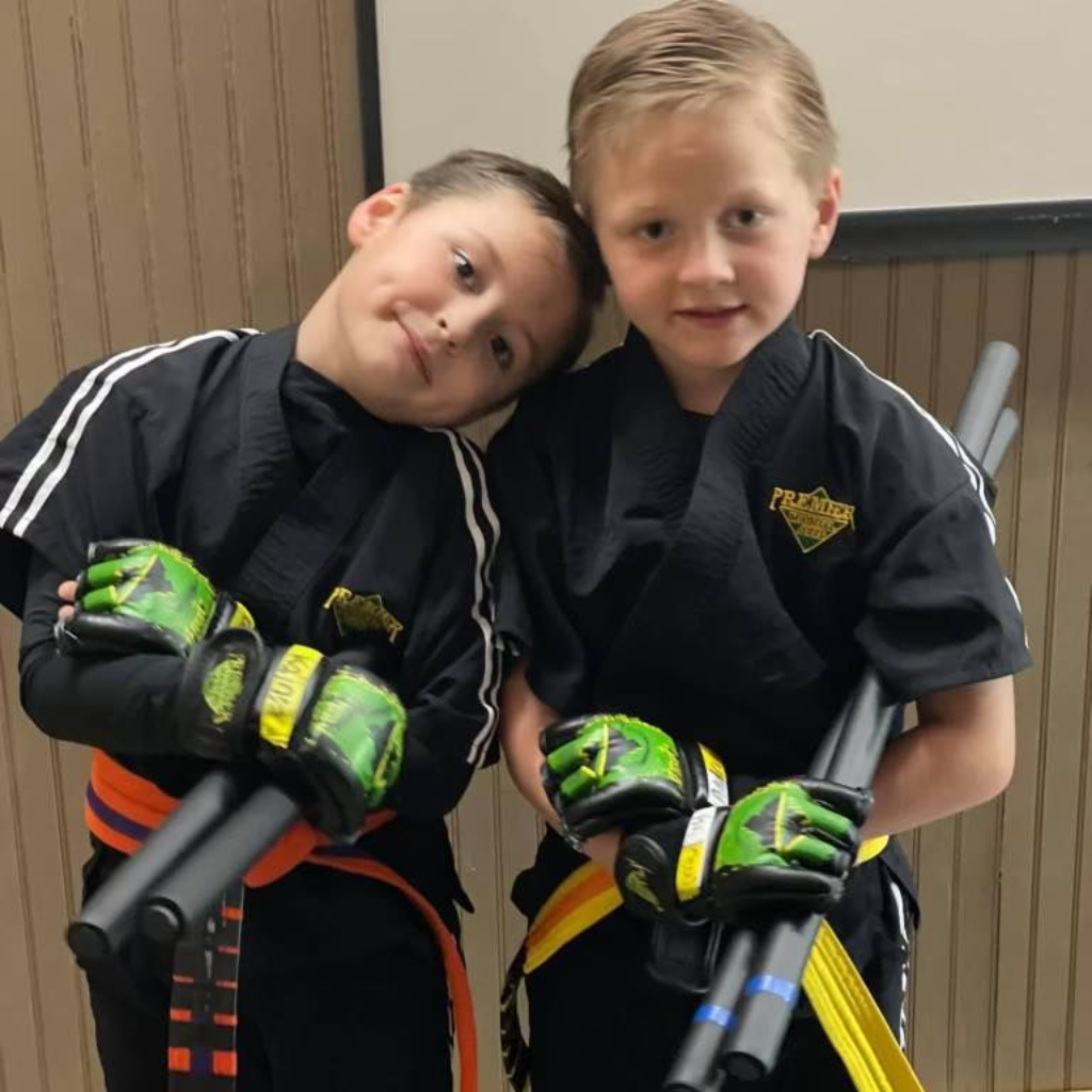 A boy and a girl are practicing taekwondo together.