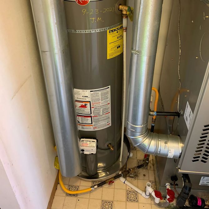 Blue Mountain Contractors LLC - A water heater is sitting next to a stove in a room.