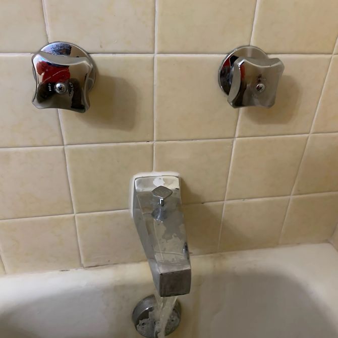 Blue Mountain Contractors LLC - A bathtub with two chrome faucets on the wall