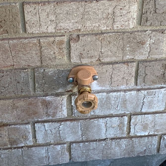Blue Mountain Contractors LLC - A brick wall with a copper pipe attached to it