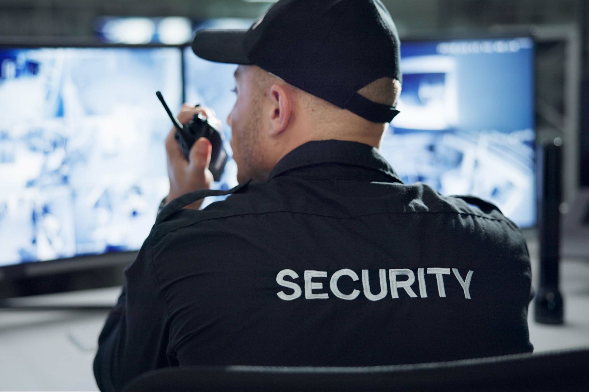 Security Guard Monitoring Security Cameras