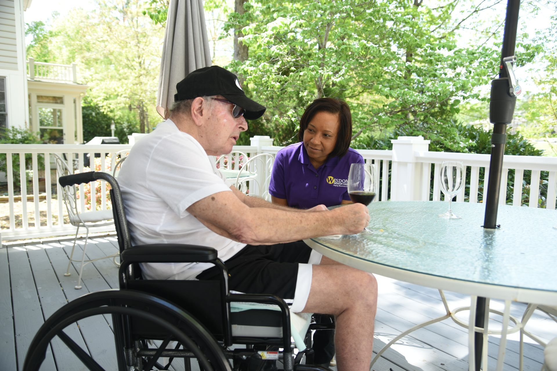 Caregiver assists an older adult with a colorful block game.