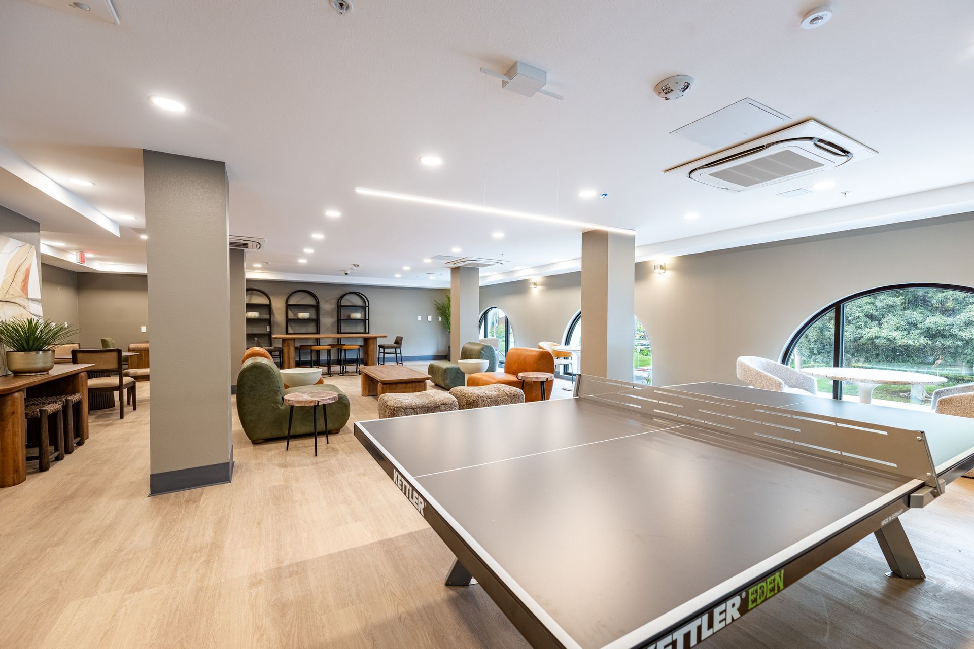 There is a ping pong table in the middle of the room.