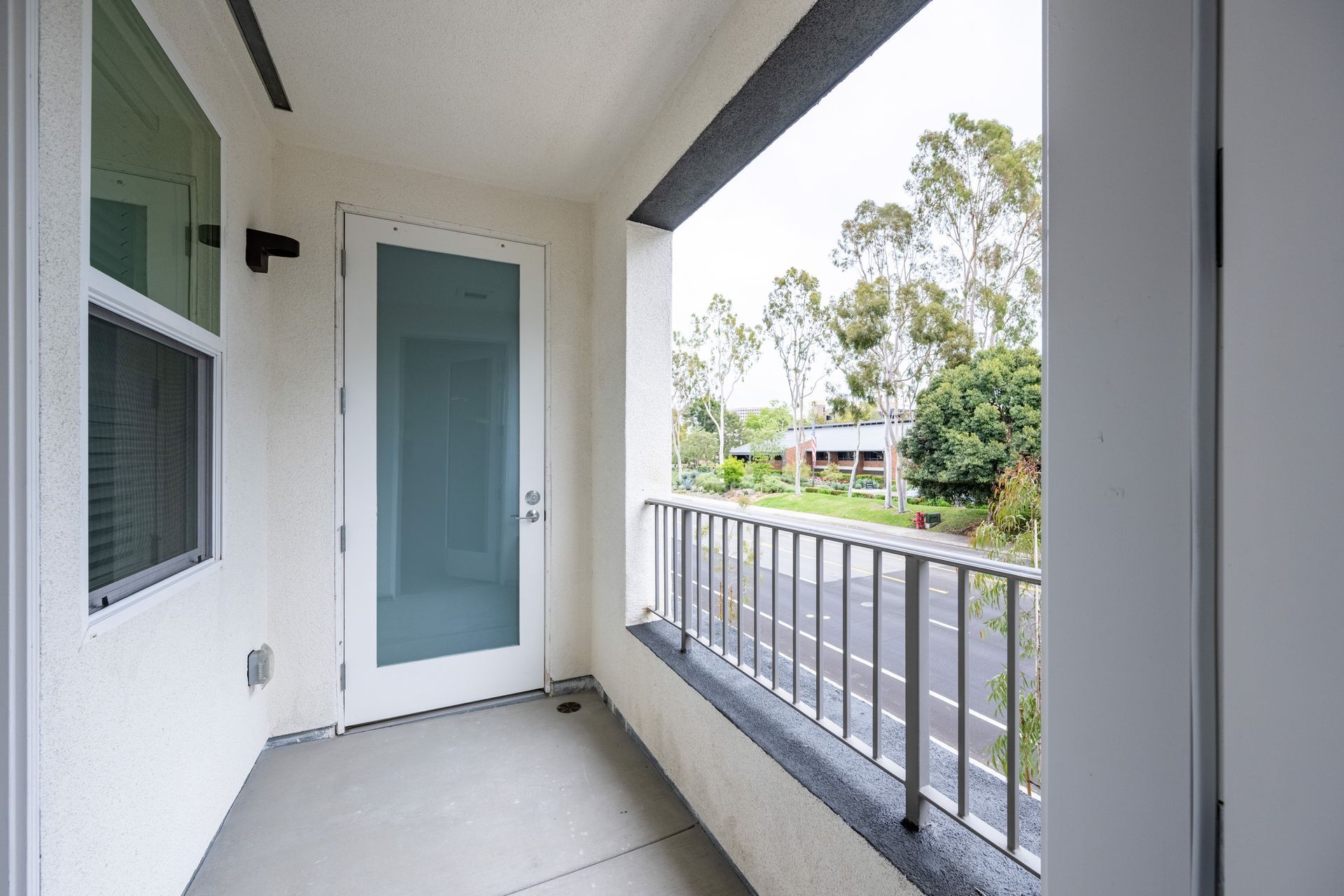 A balcony with a sliding glass door and a railing