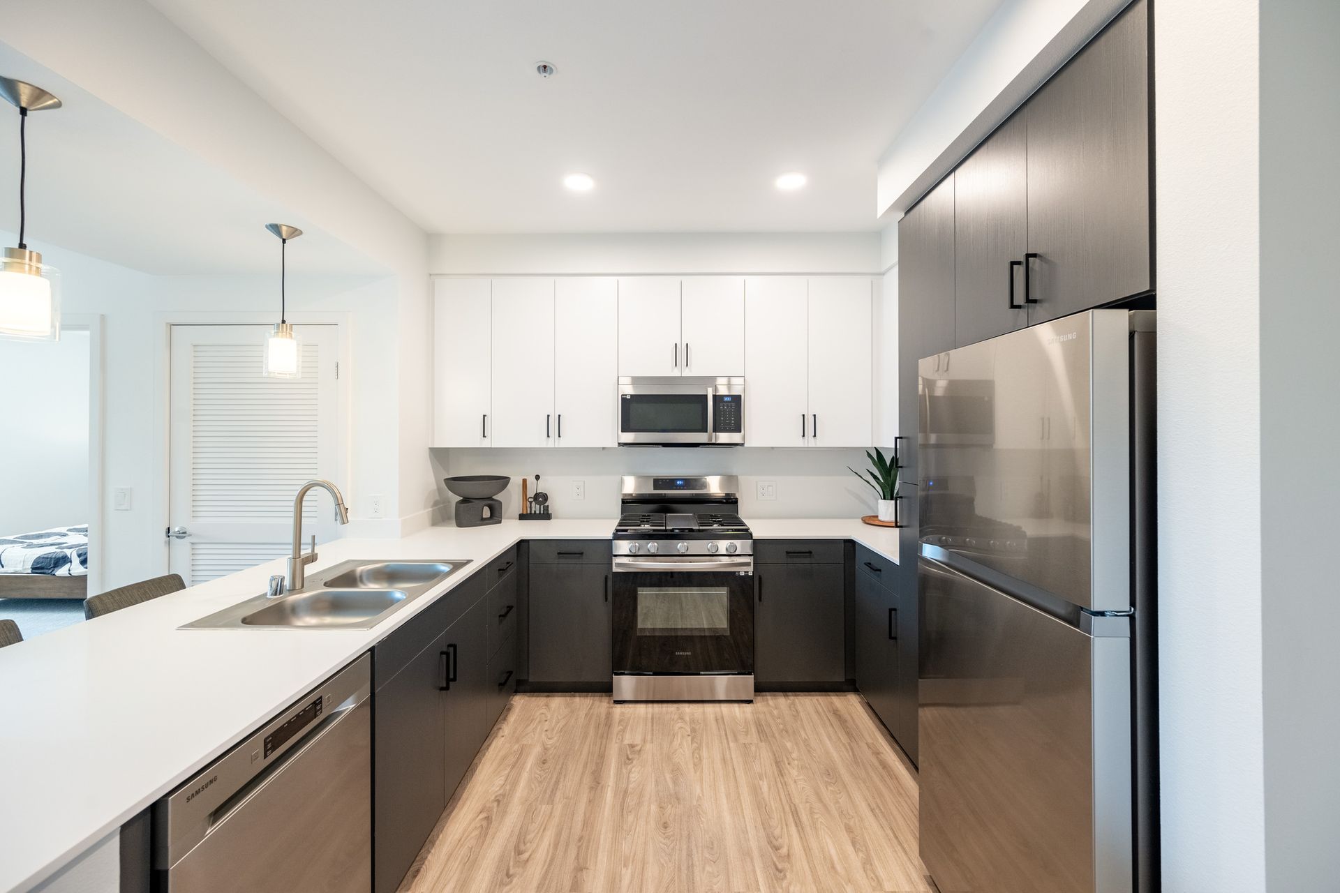 A kitchen with stainless steel appliances and white cabinets