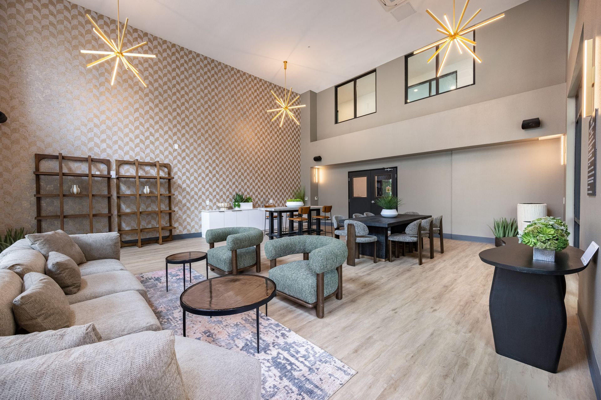 A living room with a couch , chairs , tables and a table.