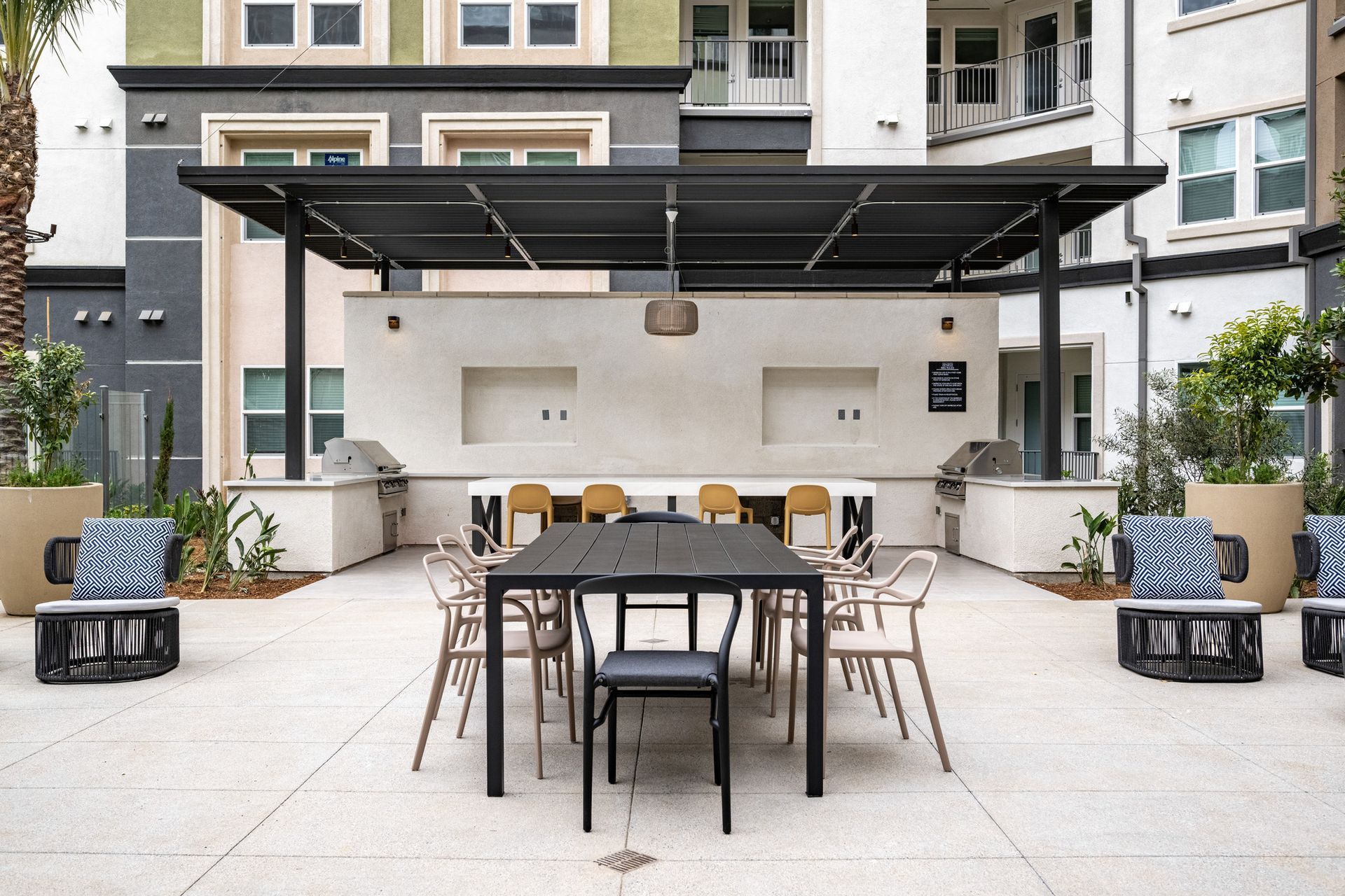 A patio area with a table and chairs under a canopy.