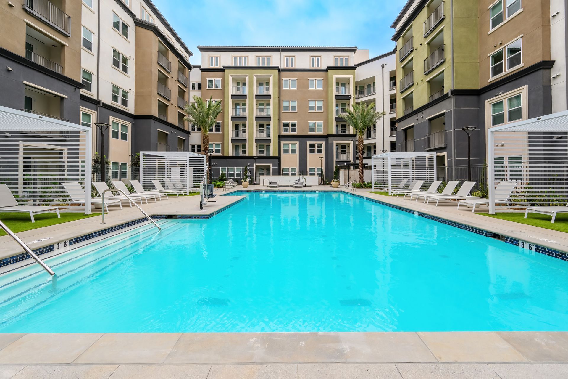 There is a large swimming pool in the middle of a building.