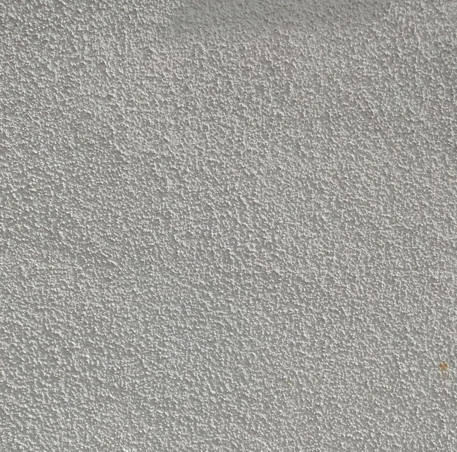 Close-up view of a textured, gray surface with a speckled pattern.