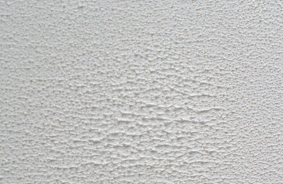 Textured, white wall with varying degrees of roughness.