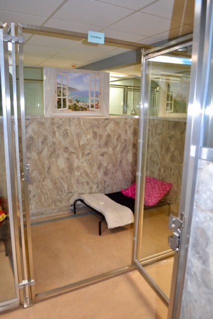 A room with a chair and a picture on the wall