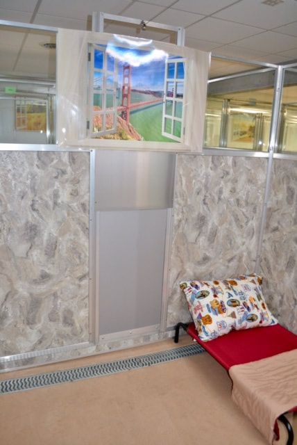 A room with a bed and a painting on the wall