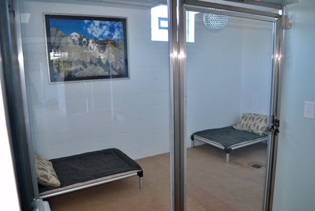 A room with two beds and a picture on the wall.