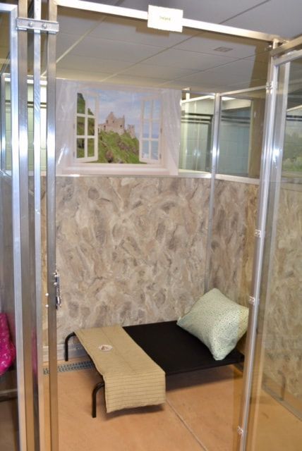 A room with a bed and a bench in it